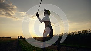 a happy child runs with a net on a sunset walk in the garden. Curious boy has fun outdoors, catching butterflies in the