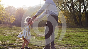 Happy child rushes into hands of father. Father spinning his daughter.