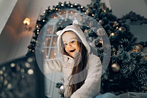 Happy child in Santa hat opening Christmas gift box