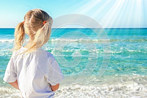 Happy child by the sea in the open air