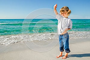 Happy child by the sea in the open air