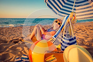 Happy child sitting on the sunbed