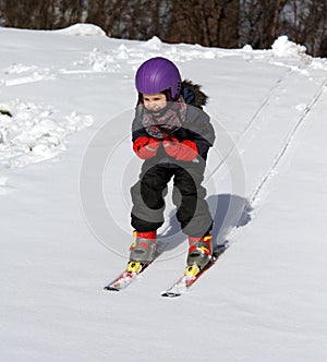 Happy child on ski in winter