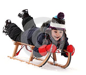 Happy child on sledge in winter