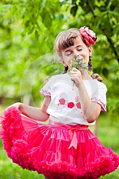 Happy child smelling wildflowers