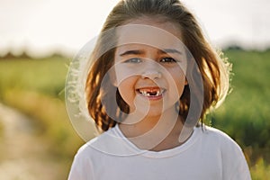 Happy child. Smiling child girl. Cheerful kid outdoors in nature