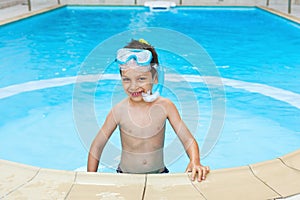 Happy child snorkeler in pool