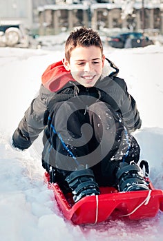 Happy child on the snow slide