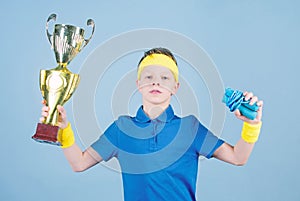 Happy child sportsman hold champion cup trophy. Fitness and diet. Energy. Gym workout of teen boy winner. Success trophy