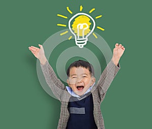 Happy Child student thinking and light bulb on the chalkboard . Cute little boy has an new idea. Innovation technology and educati