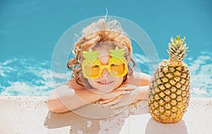 Happy child in the swimming pool. Funny kid boy playing outdoors. Summer vacation concept.