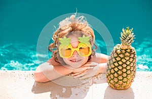 Happy child in the swimming pool. Funny kid boy playing outdoors. Summer vacation concept.