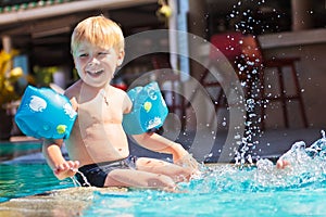Happy child in the swimming-pool
