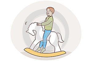 Happy child swinging on rocking horse