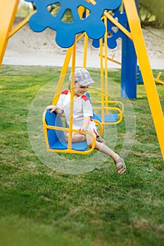 Happy child swinging on a swing