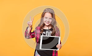 Happy child with tablet computer. Kid showing