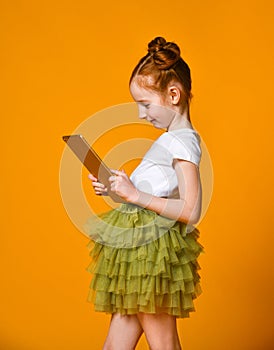 Happy child with tablet computer. Kid showing