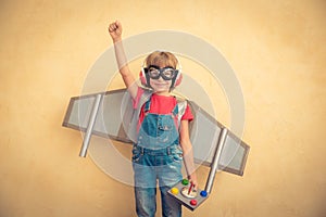 Happy child with toy jetpack playing at home