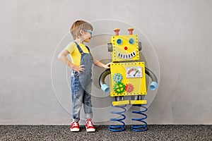 Happy child with toy robot