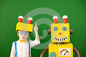 Happy child with toy robot in class