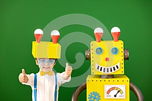 Happy child with toy robot in class