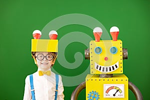 Happy child with toy robot in class