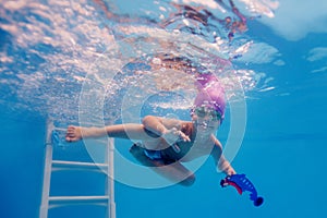 Happy child is trained to dive in the pool photo