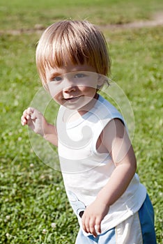 Happy child walking across meadow