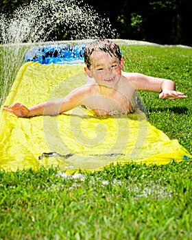 Happy child on water slide