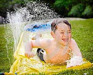 Happy child on water slide