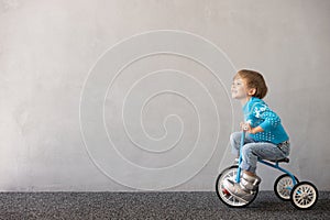 Happy child riding bike. Christmas holiday concept