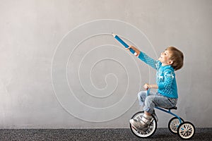 Happy child riding bike. Christmas holiday concept