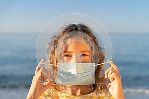 Happy child wearing medical mask outdoor