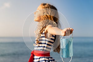 Happy child wearing medical mask outdoor