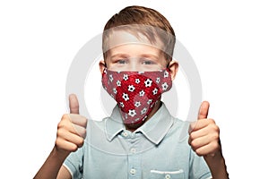 A happy child wearing a protective face mask to prevent virus infection or pollution. COVID-19 struggle and victory  concept. Hori