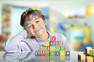 Happy child with wooden cubes