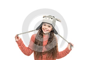 Happy childhood activity. little girl in earflap hat funny pattern. winter holiday wonder. child knitted hat isolated on