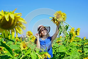 happy childhood. beautiful girl wear straw summer hat in field. pretty kid with flower. beauty of summer nature. little