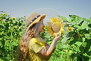 happy childhood. beautiful girl wear straw summer hat in field. pretty kid with flower. beauty of summer nature. little