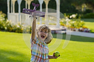 Happy childhood. Child boy toddler playing with toy airplane and dreaming future. Happy boy pilot play with airplane