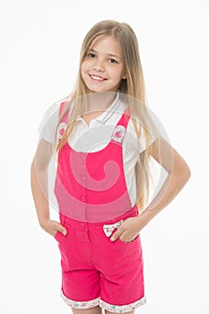 Happy childhood and childcare. Small girl smile in pink jumpsuit isolated on white. Child smiling with long blond hair