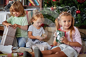 Happy  childhood on  Christmas.Kids opening Xmas presents