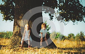 Happy childhood. Close friends. Positive little girl and boy. Happy moments. Posing outside. Cute young boy and girl