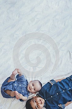 Happy childhood concept. Happy brothers portrait. 6 years boy and 6 months old baby boy having fun. Two little kids smiling to the