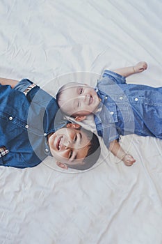 Happy childhood concept. Happy brothers portrait. 6 years boy and 6 months old baby boy having fun. Two little kids smiling to the