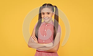 Happy childhood. Confident child yellow background. Childhood and girlhood. School education