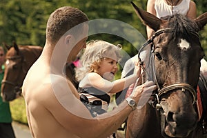 Happy childhood, fathers day. Child with muscular macho smile to animal photo