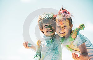 Happy childhood. Kids playing colours with smeared face. Holi festival of colors. Child girls and boy celebrate holi