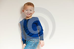 Happy childhood. Portrait of smiling blond boy child kid indoor