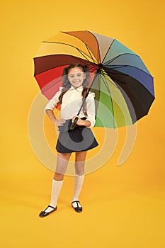 Happy childhood. Rainbow umbrella. Kid happy with umbrella. Fall weather forecast. Accessory for rainy day. Positive